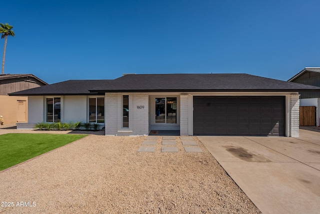 1609 W Yukon Dr, Phoenix, AZ 85027 - single story home with an attached garage, concrete driveway, a shingled roof, and brick siding