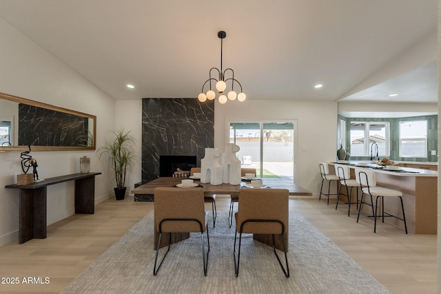 1609 W Yukon Dr, Phoenix, AZ 85027 - dining room featuring light wood-style flooring, lofted ceiling, recessed lighting, and a fireplace