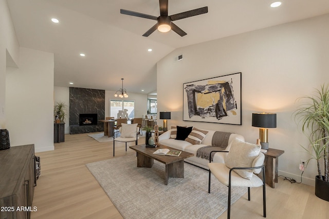 1609 W Yukon Dr, Phoenix, AZ 85027 - living room featuring ceiling fan, a premium fireplace, light wood finished floors, vaulted ceiling, and recessed lighting