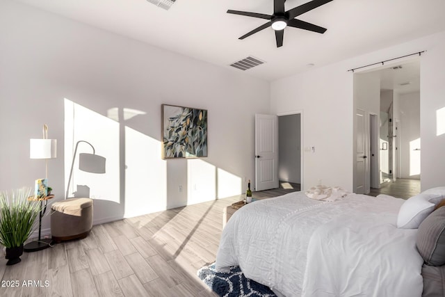 bedroom with ceiling fan and light hardwood / wood-style flooring