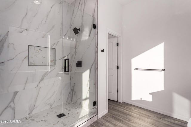 bathroom featuring hardwood / wood-style flooring and walk in shower