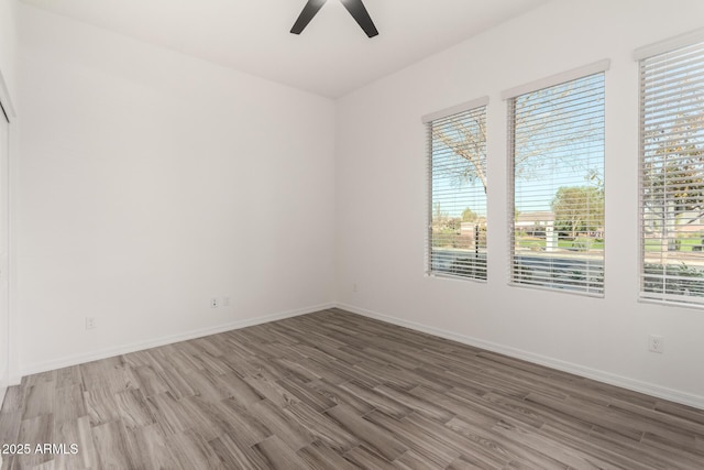 unfurnished room featuring hardwood / wood-style floors and ceiling fan