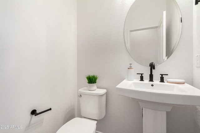 bathroom with sink and toilet