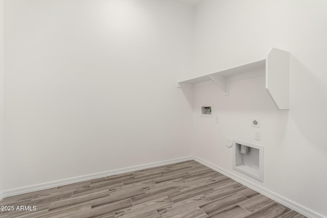 laundry room with gas dryer hookup, light wood-type flooring, hookup for a washing machine, and electric dryer hookup