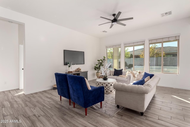 living room featuring ceiling fan and light wood-type flooring