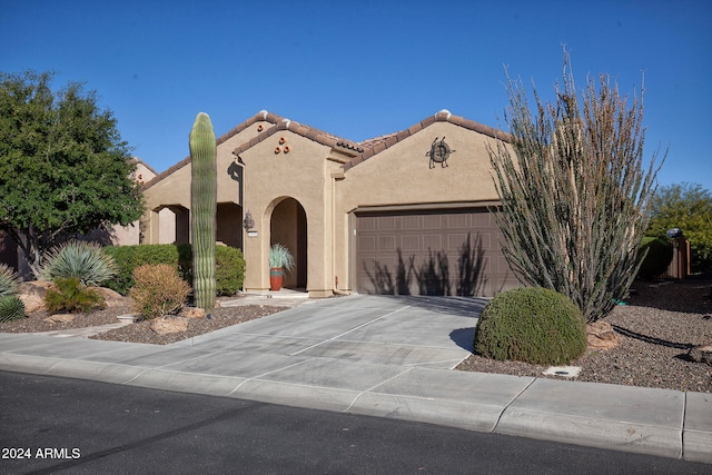 mediterranean / spanish-style house with a garage