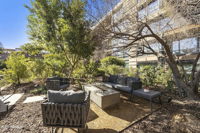 view of patio featuring an outdoor living space with a fire pit