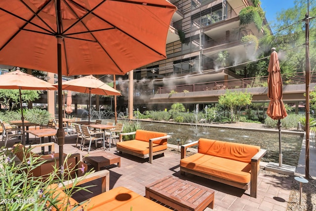 view of patio / terrace featuring outdoor lounge area and a water view