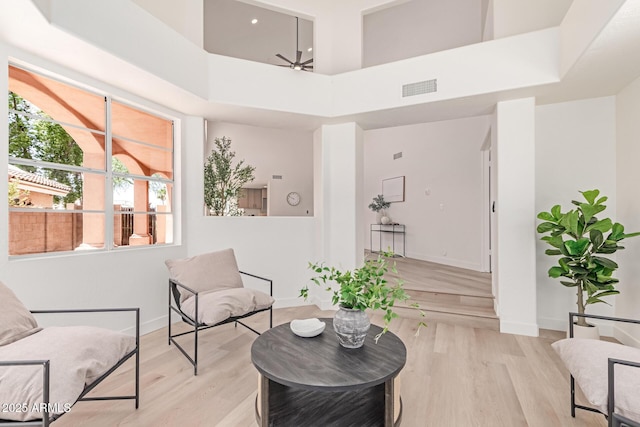 6439 E Redmont Dr, Mesa, AZ 85215 - living area with light wood-style flooring and a towering ceiling