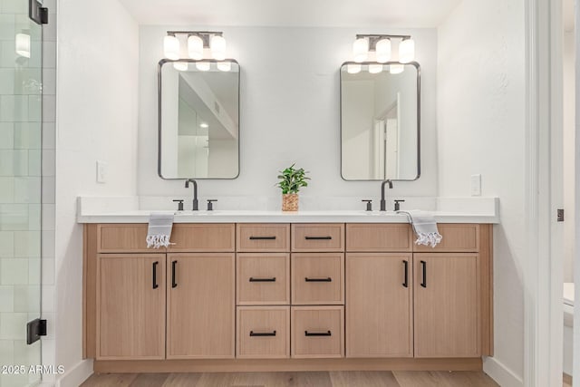 6439 E Redmont Dr, Mesa, AZ 85215 - bathroom with double vanity, wood finished floors, and a tile shower