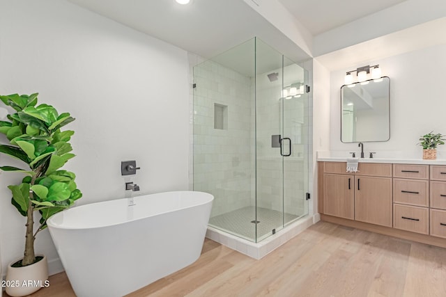 6439 E Redmont Dr, Mesa, AZ 85215 - full bath featuring vanity, wood finished floors, a stall shower, a soaking tub, and recessed lighting