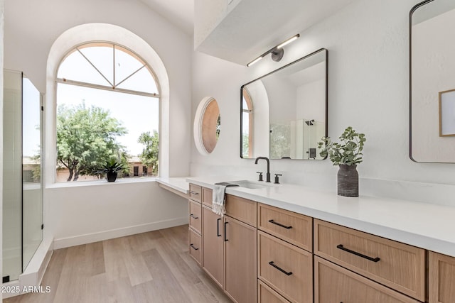 6439 E Redmont Dr, Mesa, AZ 85215 - full bathroom featuring vanity, a stall shower, and wood finished floors