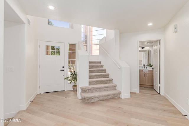 6439 E Redmont Dr, Mesa, AZ 85215 - foyer with stairs, light wood-style flooring, and recessed lighting