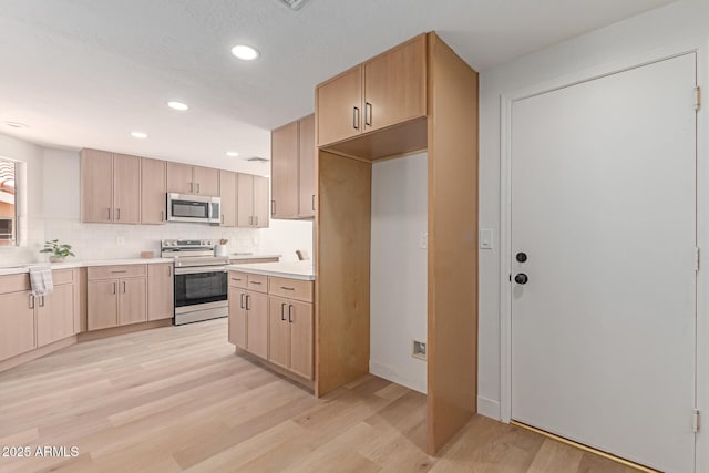6439 E Redmont Dr, Mesa, AZ 85215 - kitchen featuring appliances with stainless steel finishes, light brown cabinetry, light wood-style flooring, recessed lighting, and light countertops