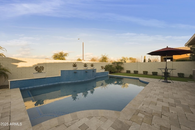 pool at dusk featuring a patio