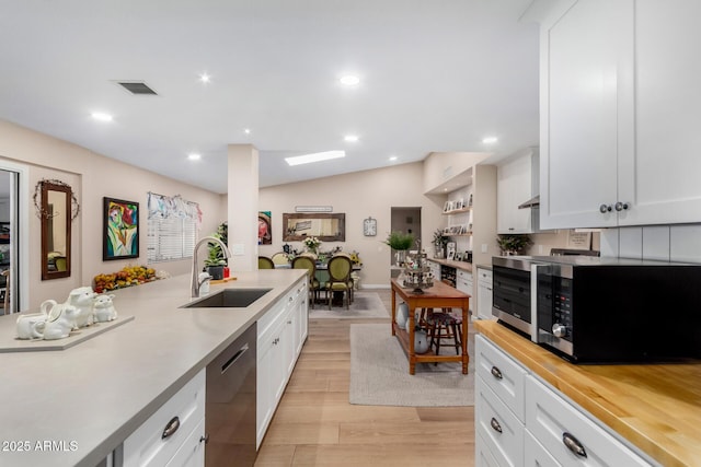 kitchen featuring sink, light hardwood / wood-style flooring, dishwasher, range hood, and white cabinets