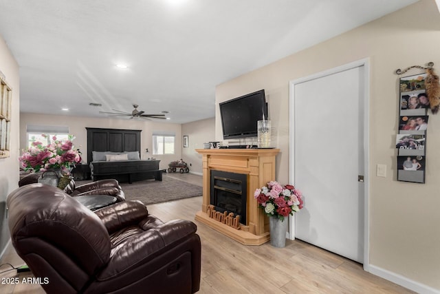 living room featuring ceiling fan and light wood-type flooring