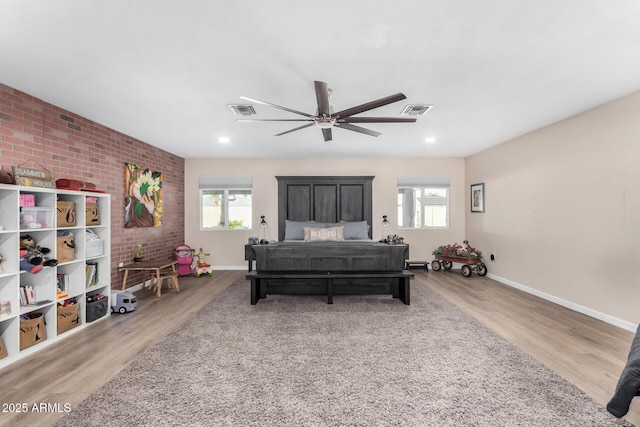 bedroom with hardwood / wood-style flooring, ceiling fan, and multiple windows