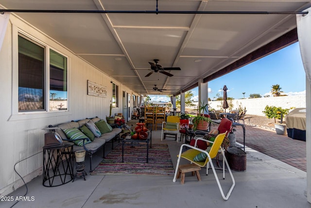 view of patio with an outdoor living space and ceiling fan