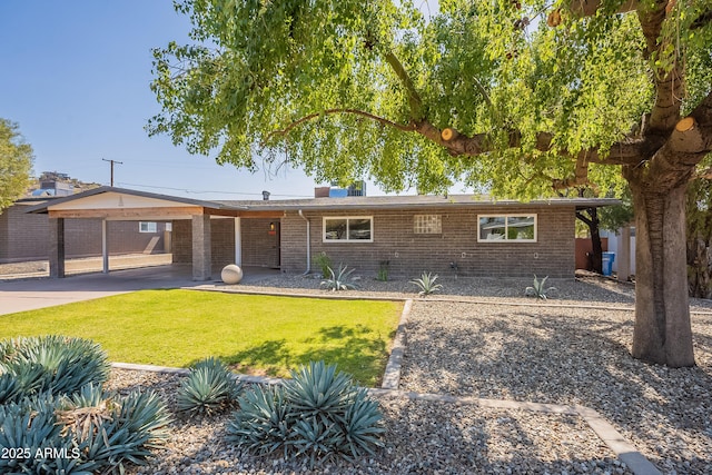 ranch-style home featuring brick siding and a front lawn