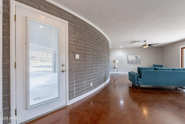 interior space with concrete flooring and ceiling fan