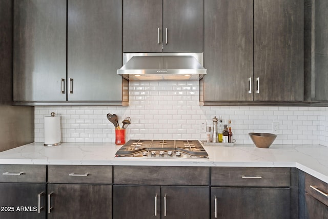 1555 E Ocotillo Rd Unit 16, Phoenix, AZ 85014 - kitchen featuring extractor fan, stainless steel gas cooktop, dark brown cabinets, and tasteful backsplash