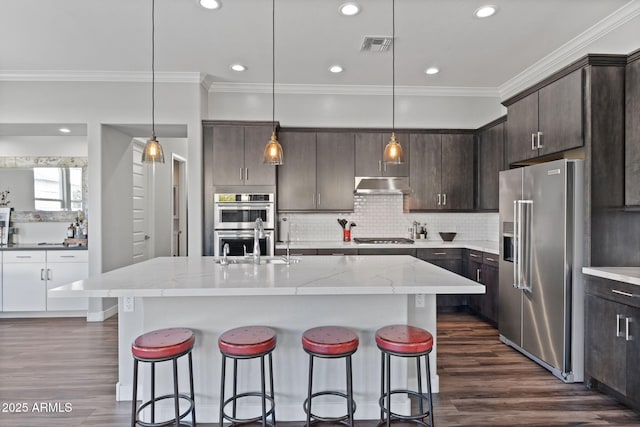 1555 E Ocotillo Rd Unit 16, Phoenix, AZ 85014 - kitchen with stainless steel appliances, under cabinet range hood, a sink, ornamental molding, and dark brown cabinets