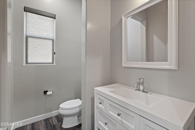 1555 E Ocotillo Rd Unit 16, Phoenix, AZ 85014 - half bath with vanity, toilet, wood finished floors, and baseboards