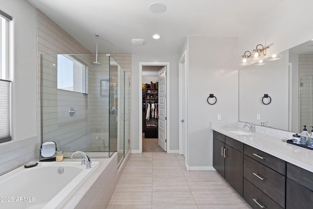 1555 E Ocotillo Rd Unit 16, Phoenix, AZ 85014 - bathroom with a shower stall, vanity, a bath, a walk in closet, and tile patterned floors