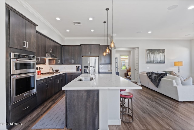 1555 E Ocotillo Rd Unit 16, Phoenix, AZ 85014 - kitchen with a sink, stainless steel appliances, dark wood-style flooring, open floor plan, and ornamental molding
