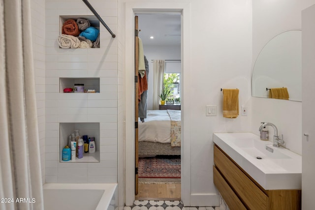 bathroom featuring vanity and shower / tub combo