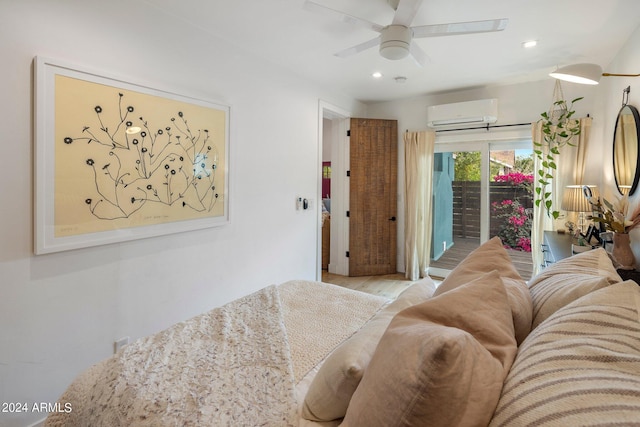 bedroom with ceiling fan, light hardwood / wood-style floors, access to outside, and an AC wall unit