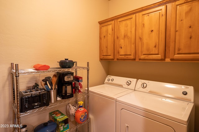 washroom featuring cabinet space and washing machine and clothes dryer