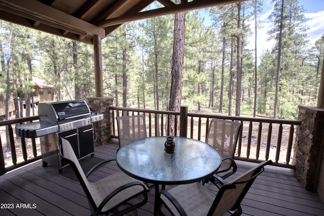 deck with grilling area and outdoor dining area