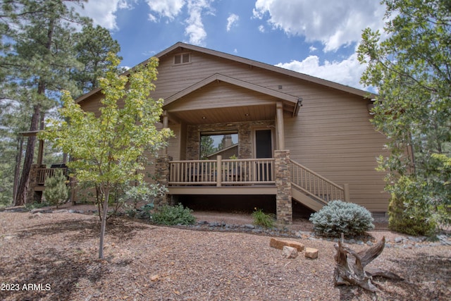 view of front of home with a porch and crawl space