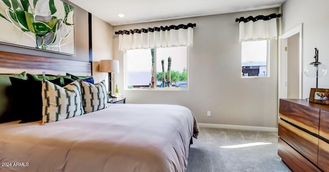 carpeted bedroom featuring multiple windows