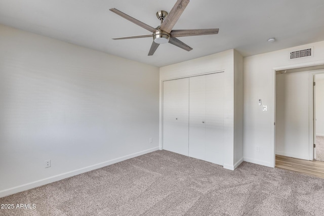 unfurnished bedroom with a ceiling fan, visible vents, baseboards, a closet, and carpet