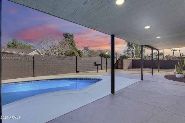 view of swimming pool with a fenced backyard, a fenced in pool, and a patio