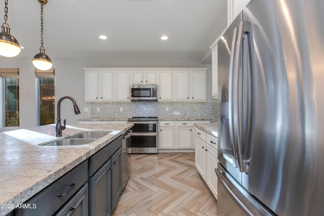 3285 Maverick Dr, Wickenburg, AZ 85390 - kitchen featuring stainless steel appliances, a sink, white cabinetry, recessed lighting, and decorative light fixtures