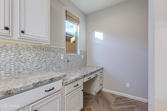 3285 Maverick Dr, Wickenburg, AZ 85390 - kitchen featuring decorative backsplash, baseboards, light stone counters, and white cabinets
