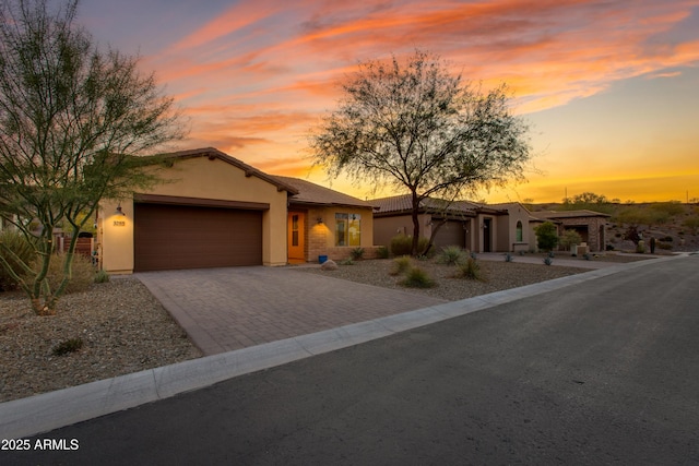 3285 Maverick Dr, Wickenburg, AZ 85390 - view of front of property with a garage, stucco siding, and decorative driveway
