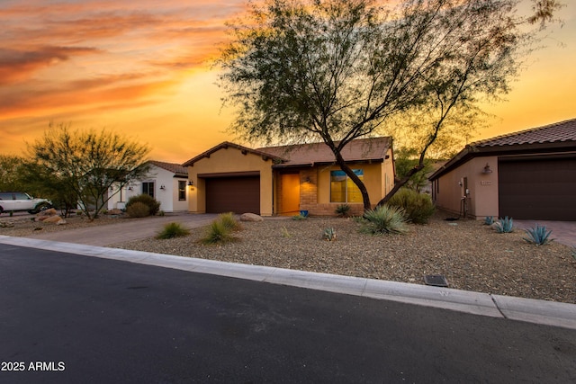 3285 Maverick Dr, Wickenburg, AZ 85390 - view of front of home featuring a garage, driveway, stucco siding, and a tiled roof