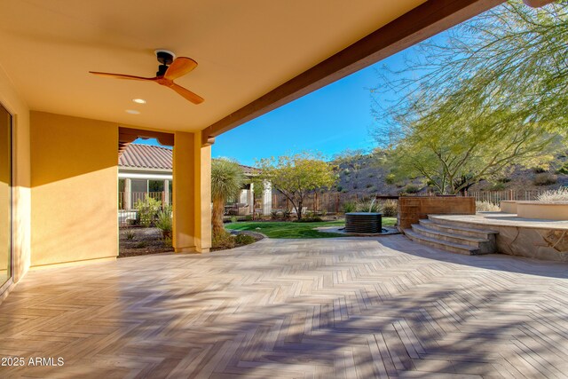 3285 Maverick Dr, Wickenburg, AZ 85390 - fenced backyard with ceiling fan and a patio