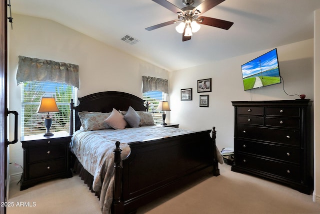 bedroom featuring light carpet, ceiling fan, visible vents, and vaulted ceiling