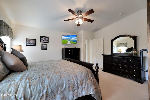 carpeted bedroom with ceiling fan, vaulted ceiling, and visible vents