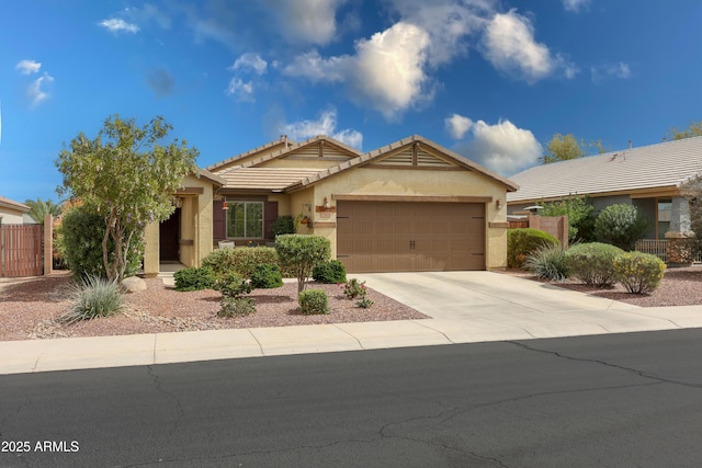 ranch-style home with a garage, a tiled roof, concrete driveway, and stucco siding