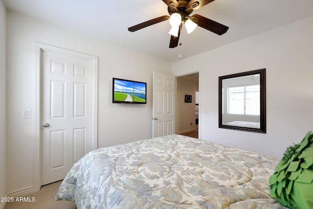 bedroom with light carpet and a ceiling fan