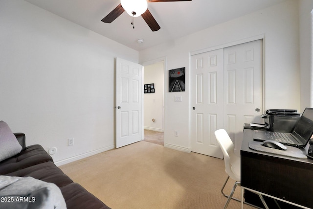 home office with light carpet, ceiling fan, and baseboards