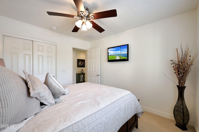 carpeted bedroom with a ceiling fan, baseboards, visible vents, and a closet