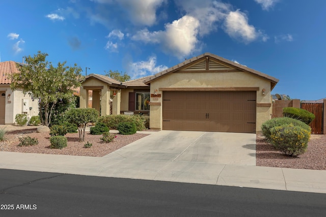 ranch-style home featuring stucco siding, fence, a garage, driveway, and a tiled roof